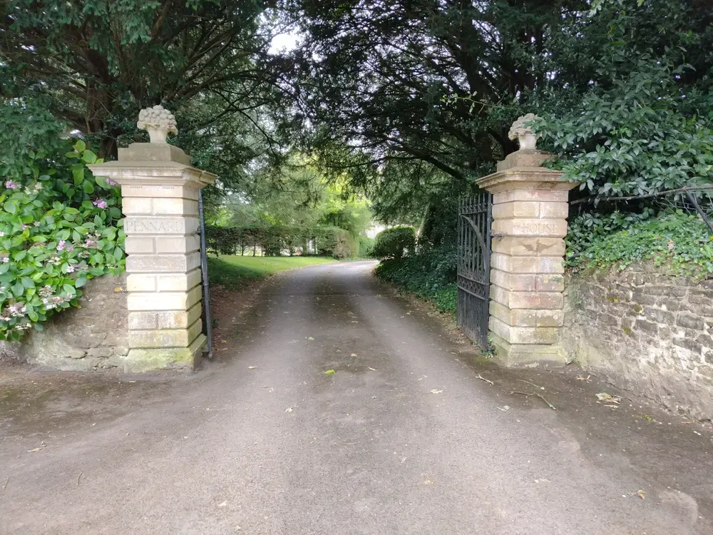 Stone-pillared driveway gate at the entrance to a private estate